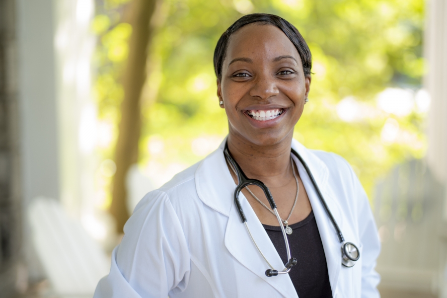 Sheveen Greene-Adenaike in a white lab coat